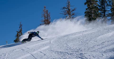 Snowboarder on a downhill run at Mountain High