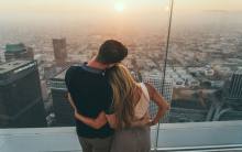 A couple watches the sunset at OUE Skyspace in Downtown LA