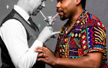 Two men sharing a martini. One white and one black. The white man is in black and white, the black man is in full color