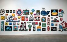 Wall of aliases by Invader at "Into the White Cube" | Photo by Daniel Djang 