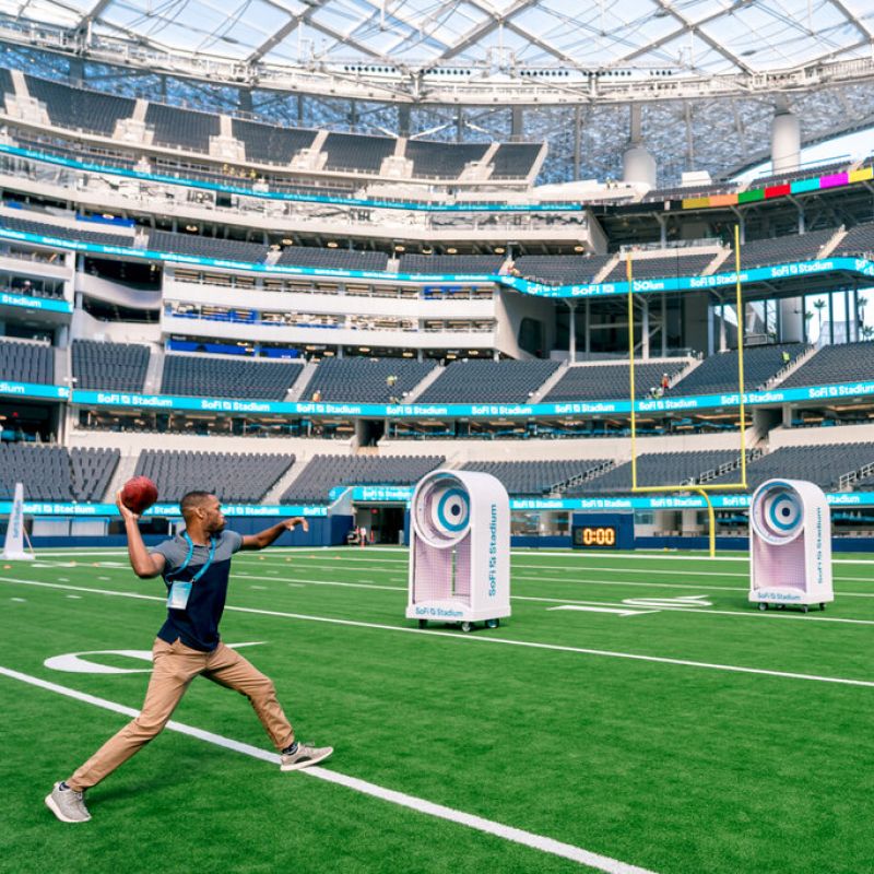 A guest throws a football at targets on the SoFi Stadium Tour.